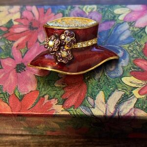 Red hat with purple rhinestone flower pin
